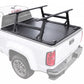 A manual tonneau cover with integrated R1 ladder rack mounted on the bed of a white pickup truck, shown from the rear three-quarter angle against a plain white background.