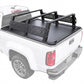 Black truck bed cover and R6 overland rack installed on the bed of a white pickup truck, shown from a rear three-quarter angle against a plain white background.