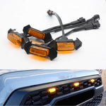 Set of amber car side marker lights with installation hardware on a white background, and their application on a vehicle's front bumper.
