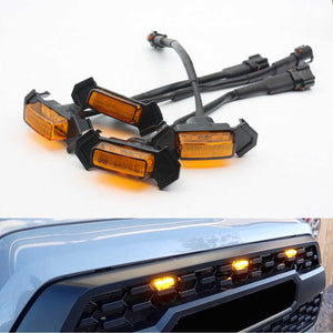 Set of amber car side marker lights with installation hardware on a white background, and their application on a vehicle's front bumper.