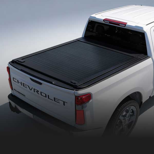 Chevrolet truck with a black tonneau cover on a gray background