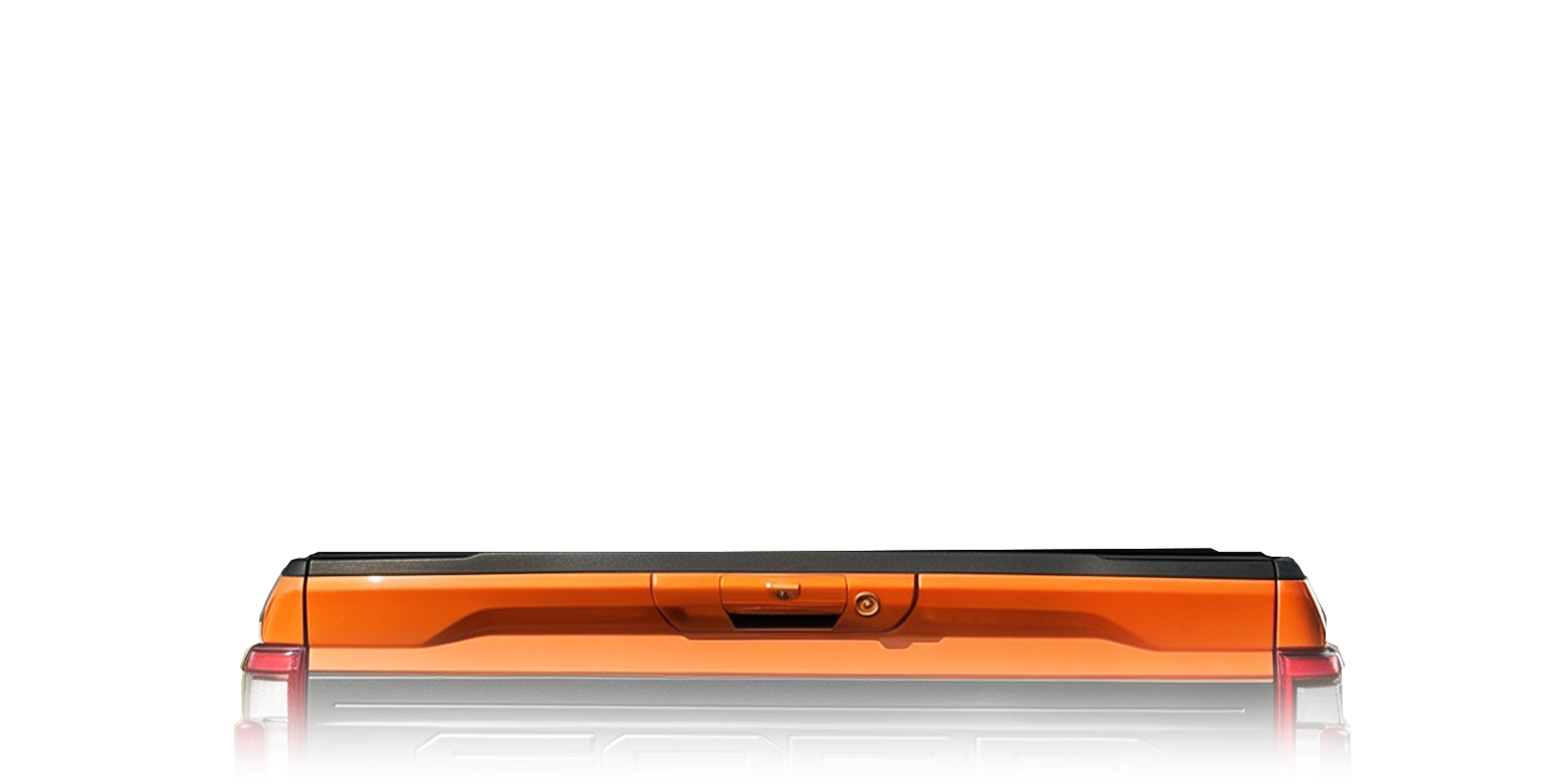 An orange and black rectangular device, likely a portable power station or electronic accessory, shown from the rear on a clean white background with a subtle reflection.
